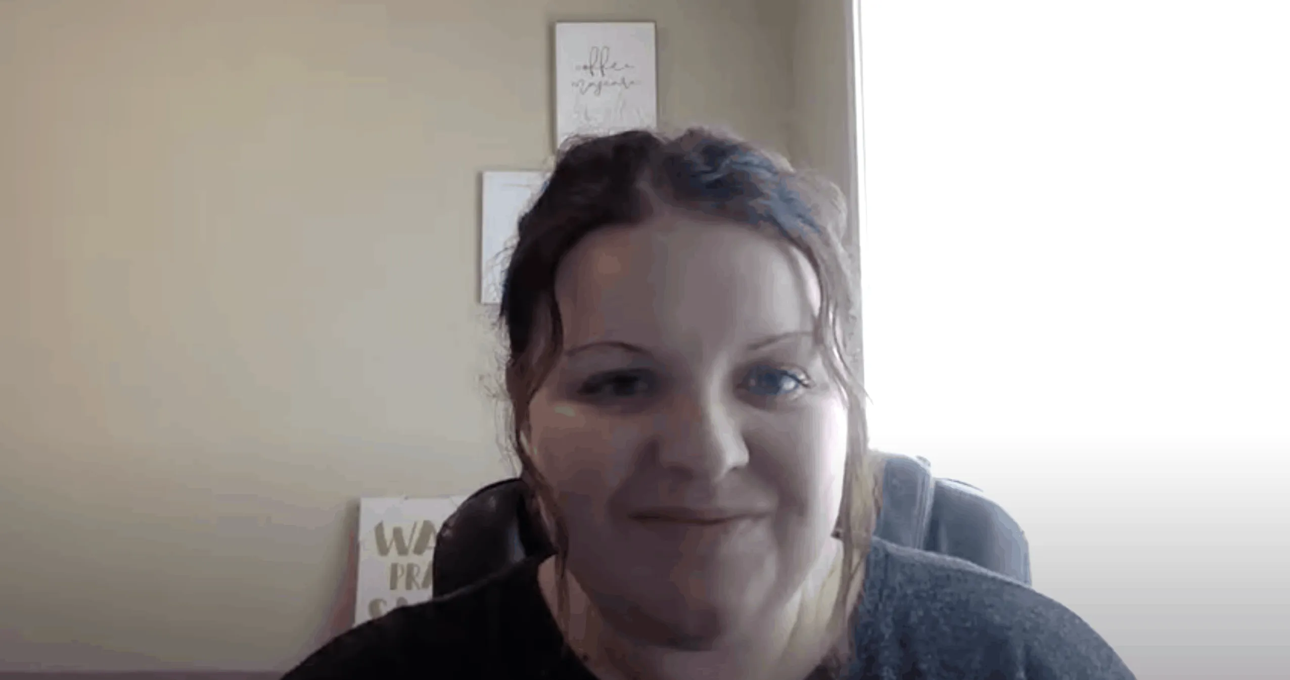 smiling woman captured in a web cam