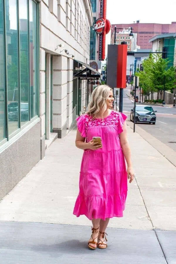 Untitled design (4) (1) micala walking on the streets wearing a pink dress